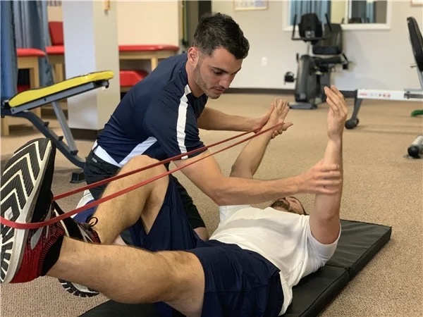 Physical therapist helping patient with exercises